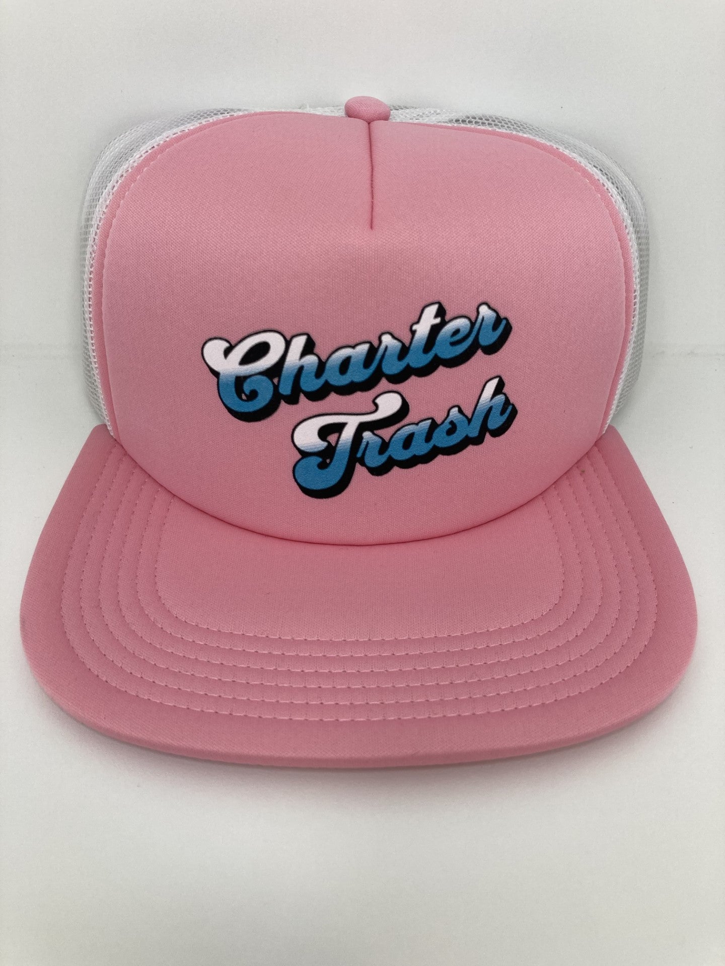 Pink & white foam front, flat bill trucker hat with Charter Trash Text.